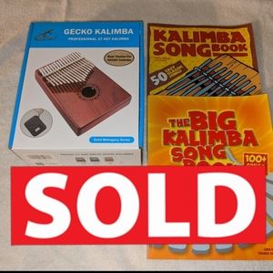 Kalimba with song books. I lowered list & shipping